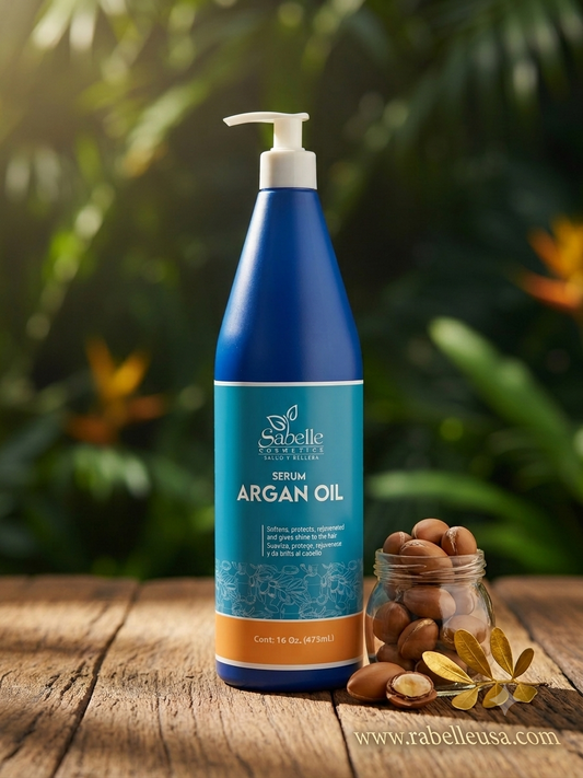 A blue pump bottle of Sebelle Organics Argan Oil serum stands on a rustic wooden surface with a small glass jar of argan nuts and dried leaves beside it. The background is a blurred tropical green foliage with warm sunlight filtering through.