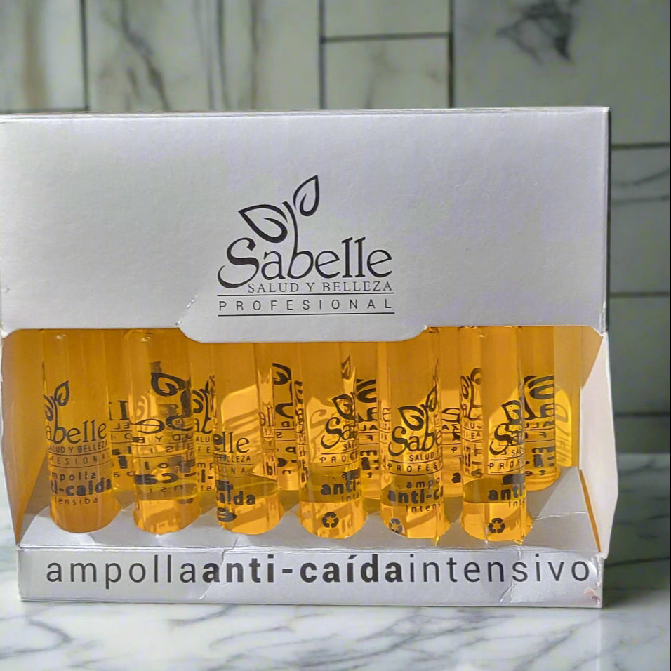 Packaging of Sabelle anti-dandruff ampoules on a marble surface with a tiled wall background.